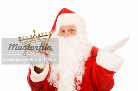 Santa Claus holding a Jewish menorah and looking confused.  Isolated on white.