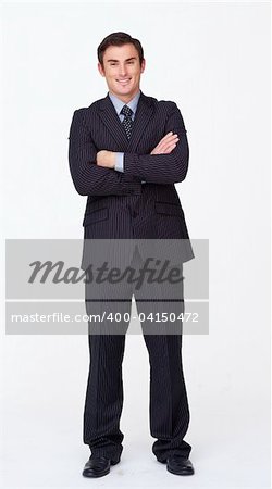 Standing businessman with folded arms against white smiling at the camera