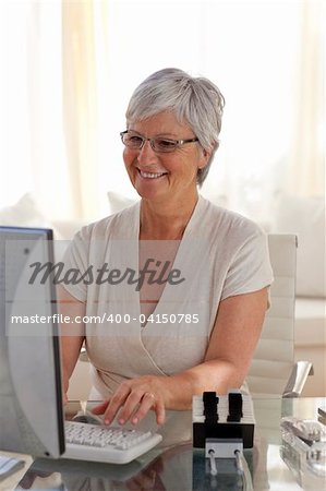 Senior woman working with a computer at home
