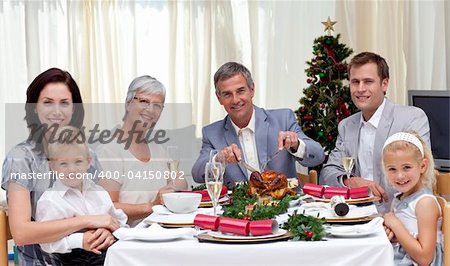 Family eating turkey in Christmas Eve Dinner at home