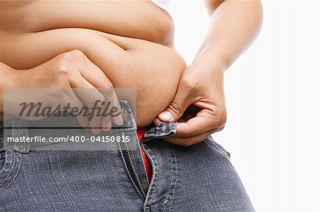 Woman trying hand to zipper her jeans, a concept for obesity issue