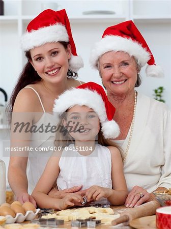 Daughter, mother and grandmother baking Christmas sweets in the kitchen