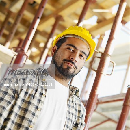 latin american construction worker looking at camera.