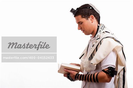 Side view of young  jewish man with book on white isolated background