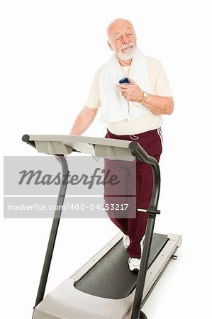 Senior man enjoys music on his mp3 player while he exercises.  Isolated.