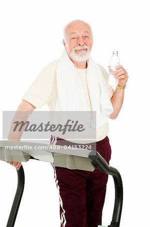 Handsome fit senior man working out and drinking bottled water.  Isolated.