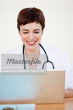 Attractive young Doctor sitting at desk in Hospital