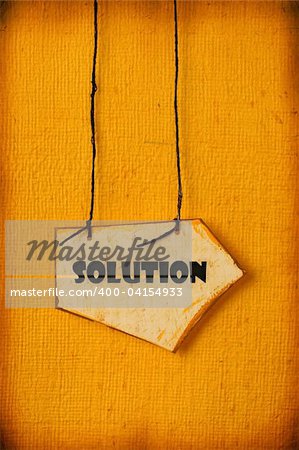 Close up of handmade paper tag with solution word