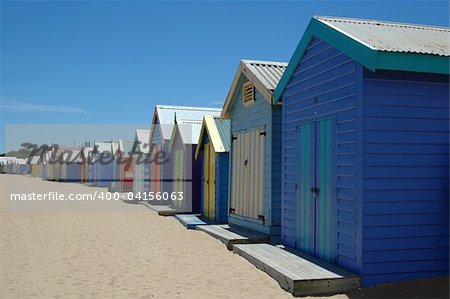 Brightly colored boat houses line the beach in Brighton, Australia