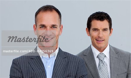 Portrait of smiling two businessmen with folded arms