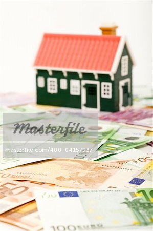 House on money field or foundation - financial concept
