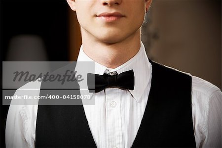 young caucasian waiter is wearing the uniform