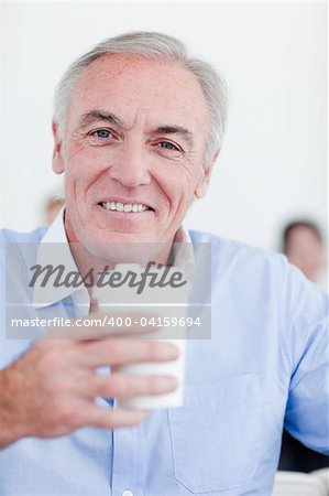 Senior businessman drinking a tea in the office