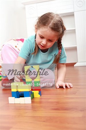 Adorable girl playing with blocks