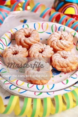 Friedcakes with candies and ribbon on the plate
