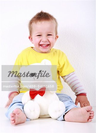 Portrait of cute toddler laughing with toy