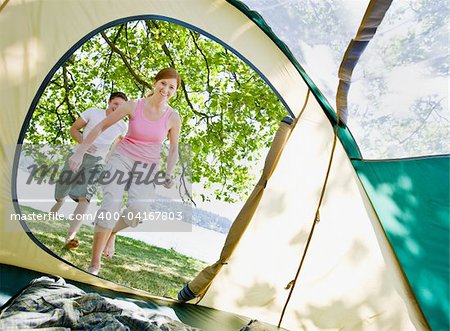 Couple running to tent