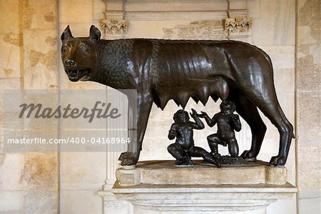 Statue of the Capitoline Wolf showing Remus and Romulus as suckling infants. Horizontal shot.
