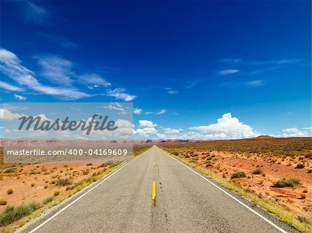 Rural State Route 261 in Utah with scenic landscape and blue sky in background. Horizontal shot.