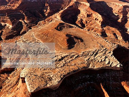 Aerial of a mesa and the surrounding canyon in a desert landscape. Horizontal shot.