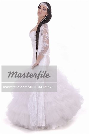 Beautiful lady dressed in wedding costume over white background