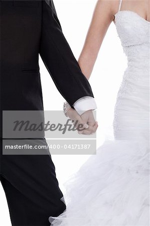 Bride and groom hands holded together over white background