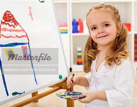 Little smiling artist girl proud of her work