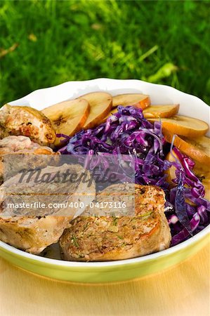 Pork medallions with sliced apples and red cabbage