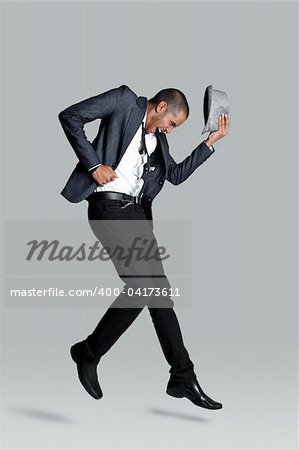 Fashion model jumps and has happy expression in studio