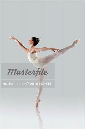 Proffessional female ballet dancer isolated in studio