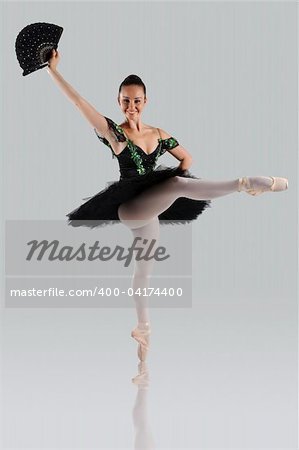 Proffessional female ballet dancer isolated in studio