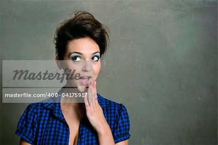 Pretty fashion model with wild hair poses in studio