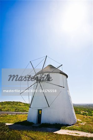 A frontal view of a windmill in action on a sunny day.