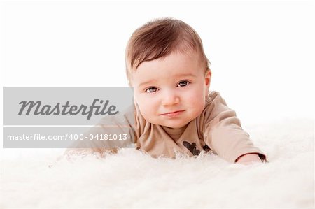 Portrait of an adorable little 6 months old baby with sad face. White background, studio shot.