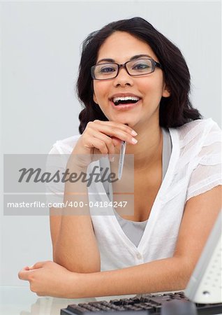 Portrait of a brunette businesswoman wearing glasses in her office