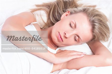 Young pretty girl sleeping in bed. Sweet dreams