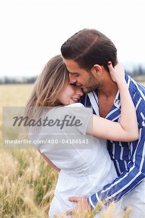 Portrait of a young Couple hugging and kissing eachotherr in the park