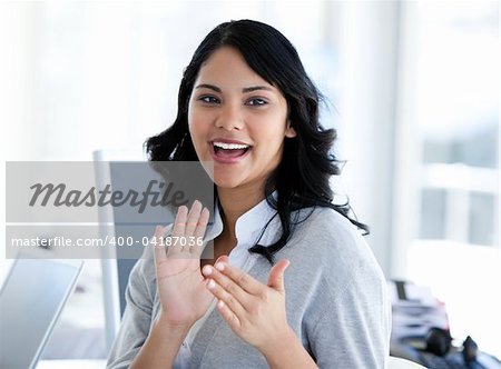 Portrait of a cute businesswoman applaudising a new colleague in the office