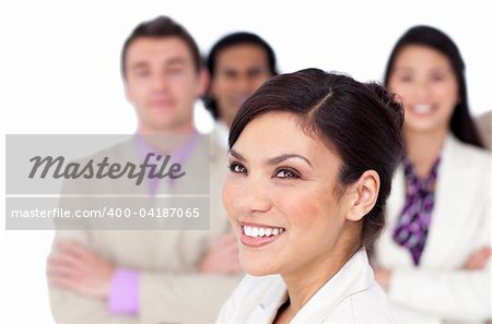 Brunette female executive presenting her team against a white background