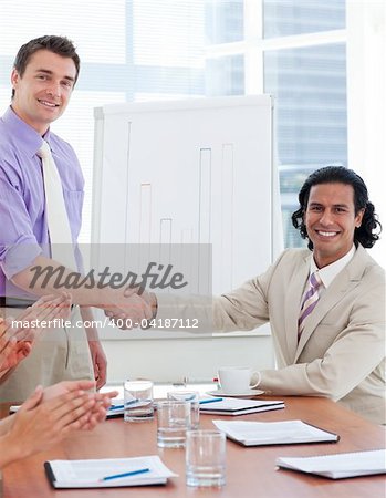 Two businessmen having a handshake in a company