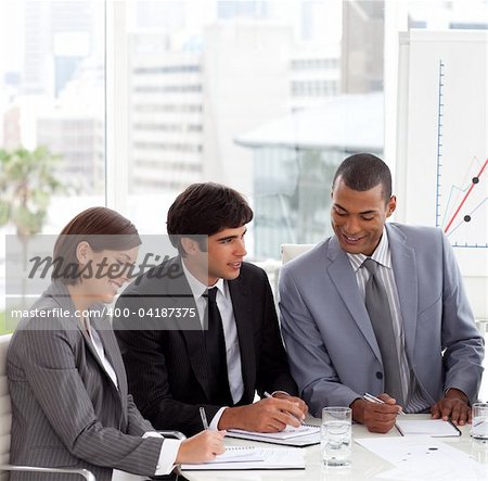 A Business group showing diversity discussing a new strategy in a meeting