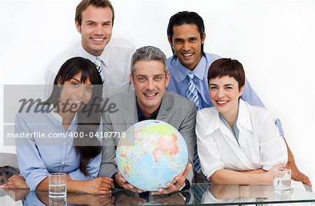 Confident business partners holding a globe and looking at the camera