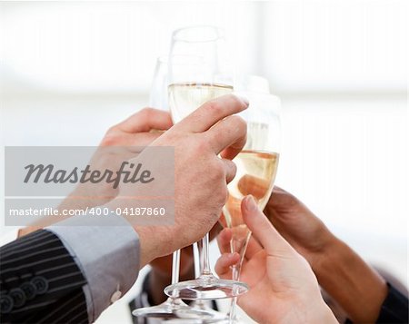 Close-up of businessmen celebrating an event with champagne in the company