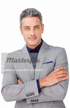 Charismatic businessman with folded arms looking at the camera