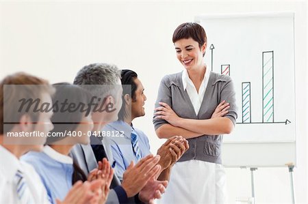 A diverse business group applauding a good presentation against a white background