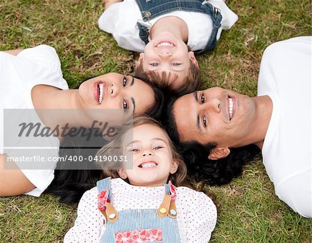 Positive family lying on the floor together outdoor