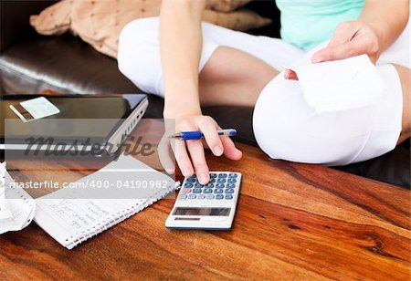 Beautiful woman doing accountancy at home