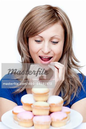 Impatient woman eating a cake against a white background