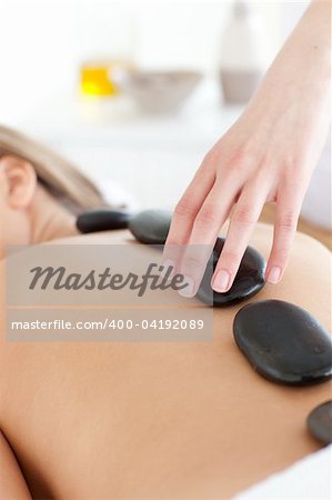 Close-up of a caucasian woman relaxing on a massage table against a white background
