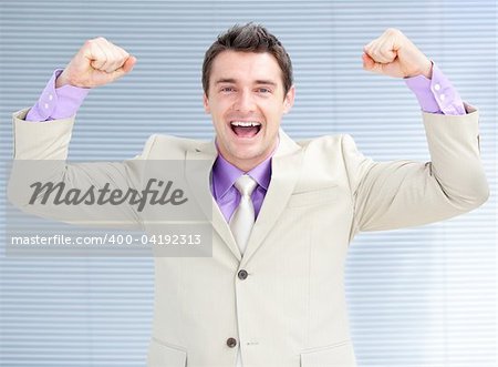 Jolly businessman puniching the air in celebration